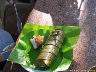 A half eaten plate of Vada and Kadubu Idli - idli made in a cylinder shaped leaf container, served on a traditional banana leaf - prominent in South India, the banana leaf lends the dish an authentic taste that is best experienced!!